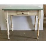White painted pine kitchen table with light green formica top with single central drawer,
