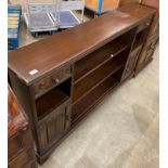 An Old Charm oak low bookcase with two end doors and drawers,