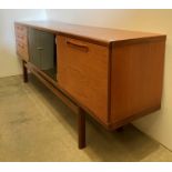 Meredew mid-century teak sideboard with two central smoked glass doors, three drawers to left side,