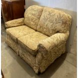 Golden and floral fabric upholstered two seater settee with removable covers (Saleroom location: