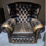 Dark brown leather Chesterfield club armchair,