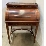 Edwardian mahogany cylinder top desk with three-quarter brass gallery over two small drawers,