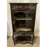 Ebonised French style carved display cabinet with single drawer and glazed door,