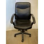 A black vinyl upholstered swivel office armchair (Saleroom location: MW MA2)