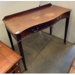 A mahogany console side table with serpentine front, two drawers, on tapered legs and castors,