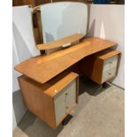 A mid-century G-Plan Boomerang two-tier oak mirrored back dressing table with two white drawers to