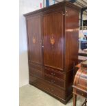 Large mahogany wardrobe with two doors inlaid with urns, four dummy drawers and long drawer below,