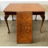 A burr walnut extending dining table (one extra leaf), on cabriole legs,