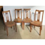 Four matching oak dining chairs with central panel carved with a flower (Saleroom location: MWFL)