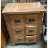 A light oak six drawer chest of drawers,