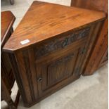 An Old Charm oak single door, single drawer low corner cupboard,