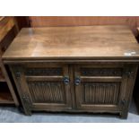 An Old Charm carved oak two door entertainment cabinet,