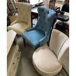 A light blue upholstered lounge chair with studded detail,