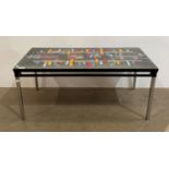 A retro tiled top coffee table with black metal frame, on chrome legs,