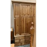 A pine two door wardrobe with six under drawers,