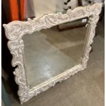 A white-painted wood wall mirror,