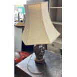 A gilt and blue patterned table lamp complete with shade,