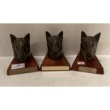 Three Tudor bronze dog head awards on wooden plinths (saleroom location: S3 QC03)