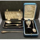 Two silver gift sets, silver egg cup and spoon with 1914 hallmark, by W Greenwood & Sons,