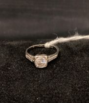 A collar-set diamond ring (please note: the main centre stone is not a diamond),