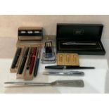 Contents to box - rolled gold propelling pencil, assorted fountain pens, vintage desk-top calendar,