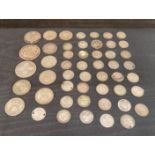 Fifty assorted silver coins including, one shilling pieces, half crown, floral,