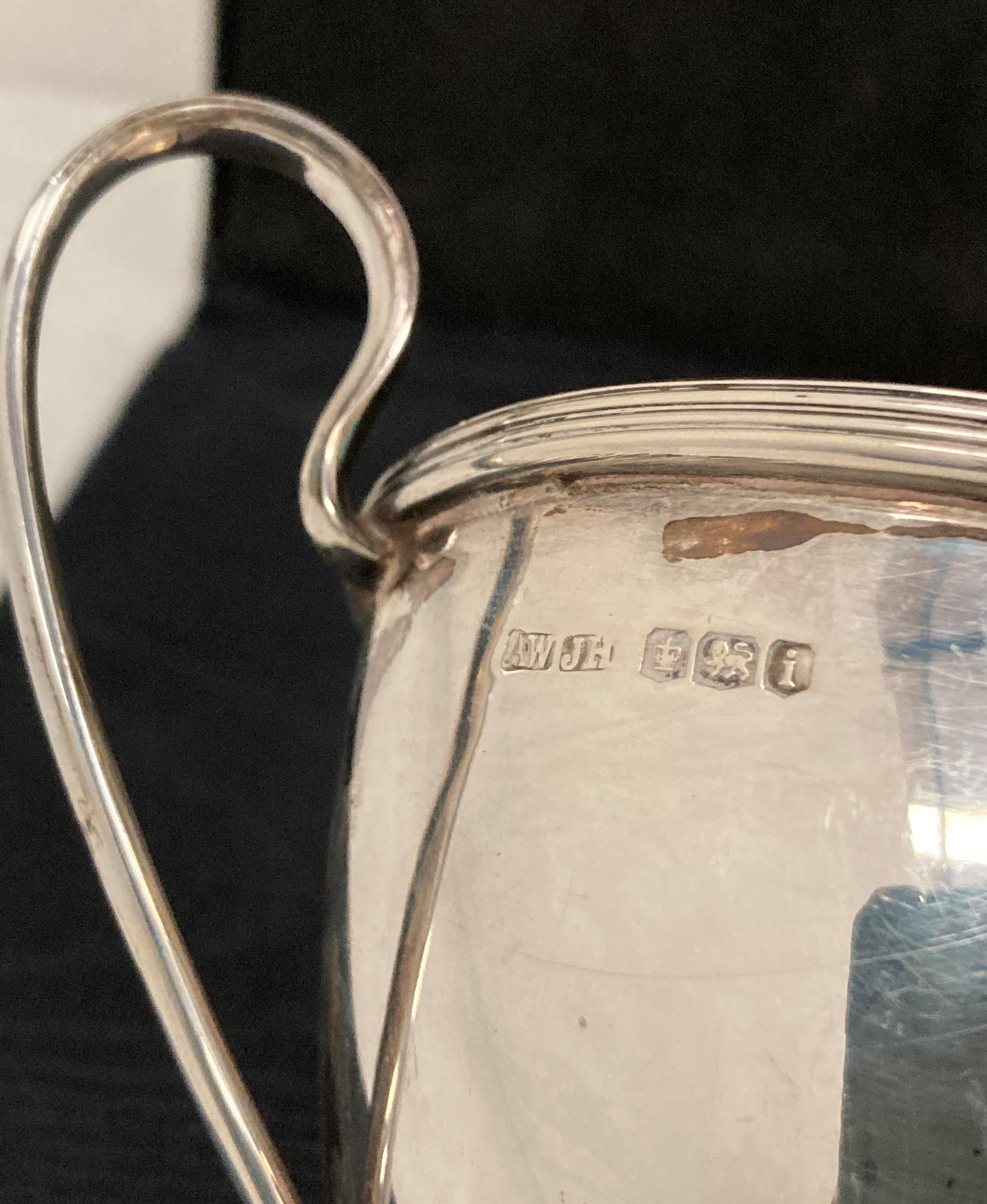 Silver [hallmarked] double handled cup with a matching cream/milk jug by AW & JH, Sheffield 1926, - Image 2 of 4