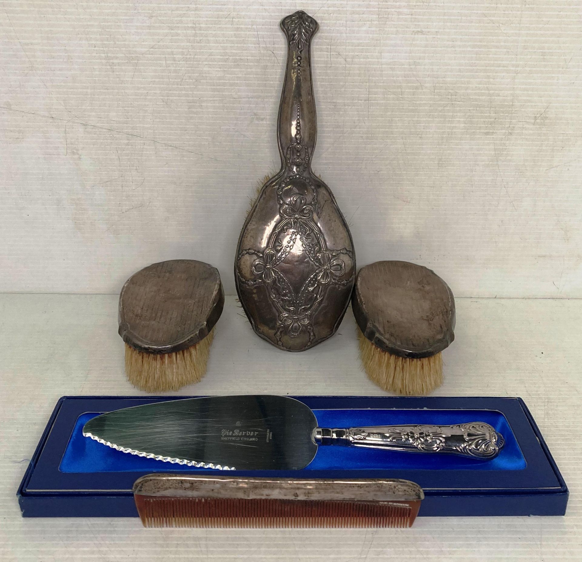 Five silver [hallmarked] items, two clothes brushes with matching comb, 1925, hair brush 1909,