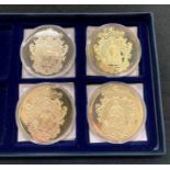 A set of four gold plated limited 'Bank Note' coins including ten shilling, £50, £5, £1,