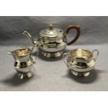 A silver three-piece tea service [hallmarked] (dated 1935, London) by W Greenwood & Sons.