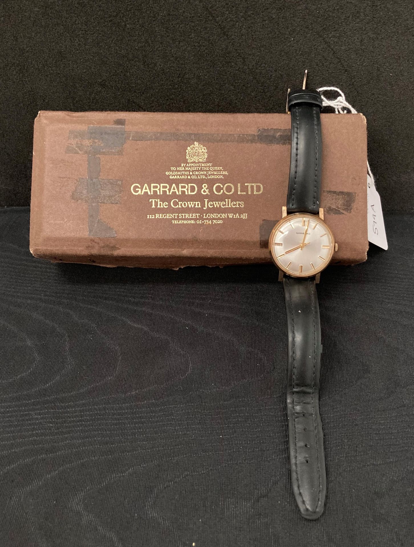 GENT'S GARRARD WRISTWATCH in gold (no hallmarks visible) with black and leather strap,