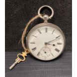 A Silver pocket watch in working order, complete with key.