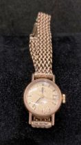 9ct gold "Omega" "Ladymatic" wrist watch with a 9ct gold chain link strap, 1960s.
