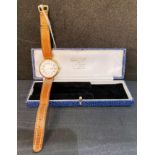 18ct gold watch with white enamel face and brown leather strap.