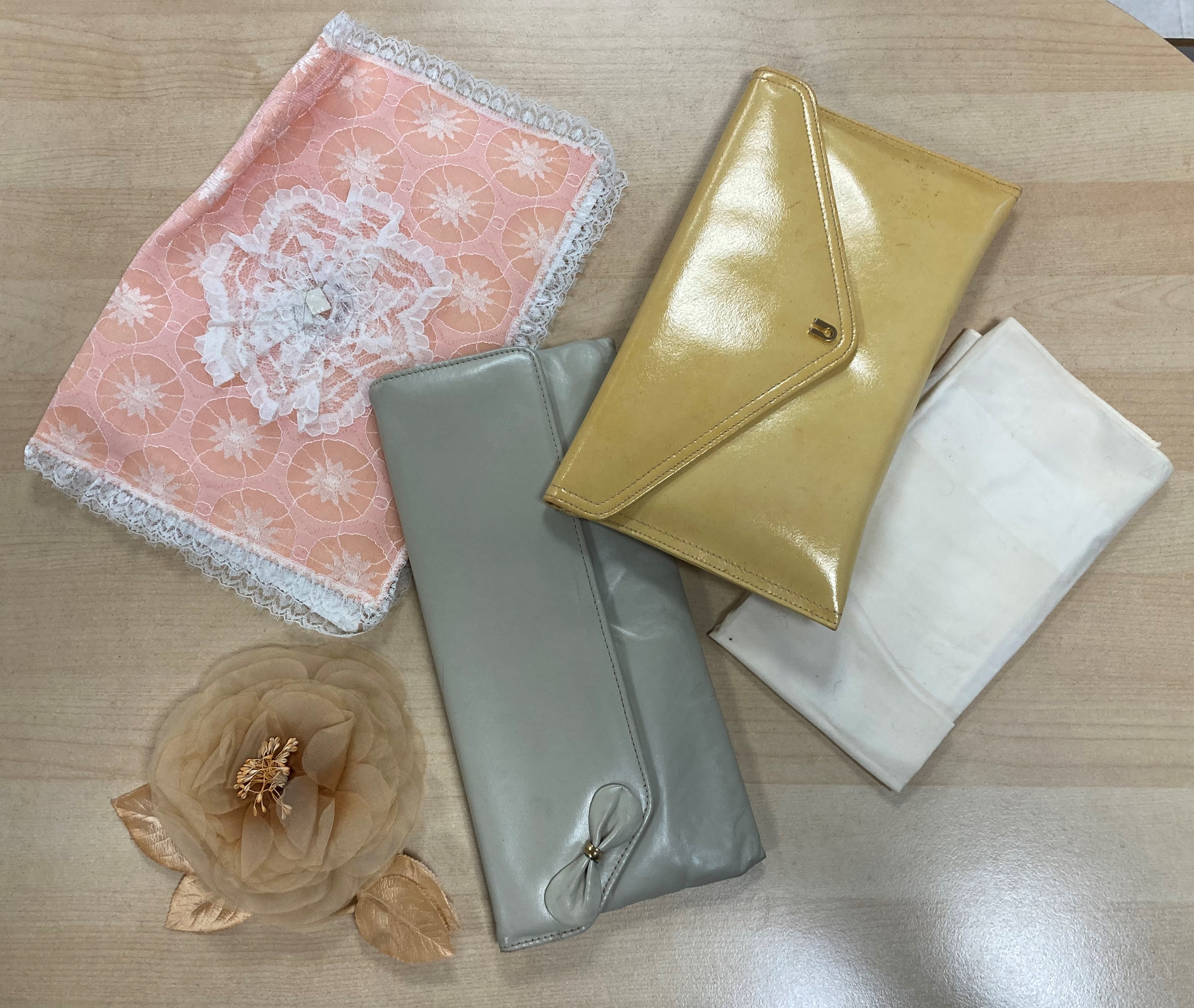 A bundle of pastel coloured bags and accessories including, two clutch bags,