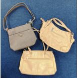 Three beige-tone day/handbags with multiple zip compartments and minimalist details including a