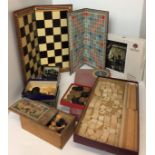 Seven games including wooden Scrabble, chess and draught board, draughts, chess men,