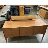 A Golden Key teak finish six drawer mirror back (loose panel) dressing table,