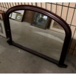 A dark wood finish framed arch top wall mirror,