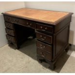 Mahogany twin pedestal desk with light brown tooled leather top,