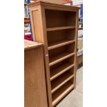 A pine six shelf open bookcase unit,