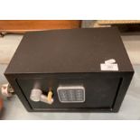 A small digital safe complete with key,