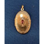 9ct gold oval locket with central red stone - weight 5.