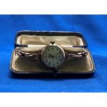 9ct gold (hallmark 375) ladies wrist watch with white enamel face and gold link sprung strap,