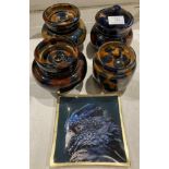 Four assorted size blue and brown glazed tobacco jars/storage jars and a glass eagle tray (saleroom