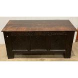 Dark stained oak carved front chest with lift top,