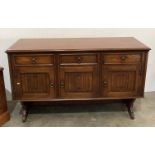 Jaycee Furniture oak three drawer three door sideboard with scroll panels,