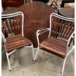 Dark stained wooden sun-burst garden table on white metal frame with two matching arm chairs and