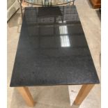 Black granite topped dining table on light oak finish frame - 110 x 70cm (saleroom location: MA7)