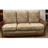 Ercol Renaissance high back standard three-seater sofa with light brown floral-patterned upholstery